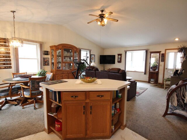 kitchen featuring light colored carpet, open floor plan, open shelves, and ceiling fan with notable chandelier