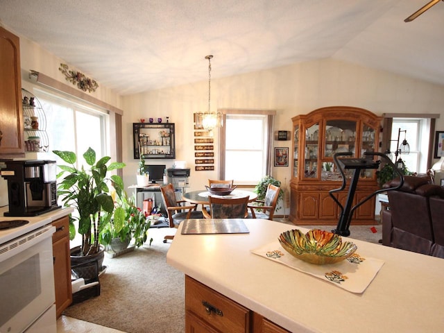 kitchen with lofted ceiling, open floor plan, light countertops, and carpet