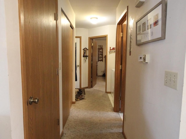 hall featuring light carpet