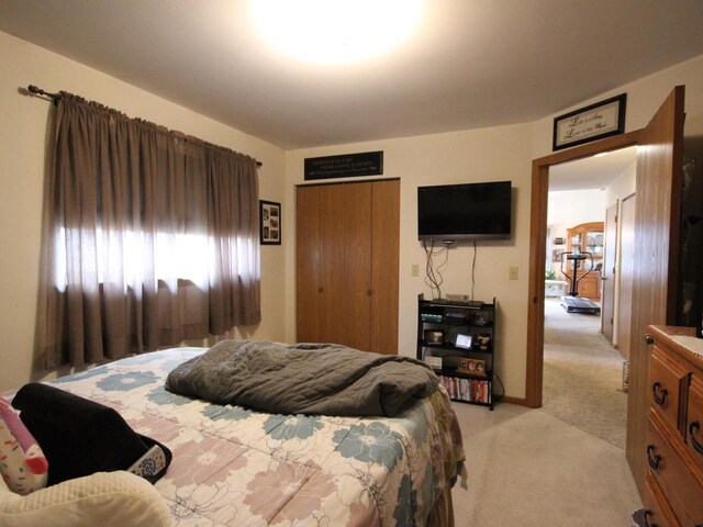 bedroom featuring a closet and light carpet