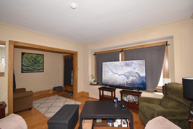 living room with baseboards and light wood-style flooring