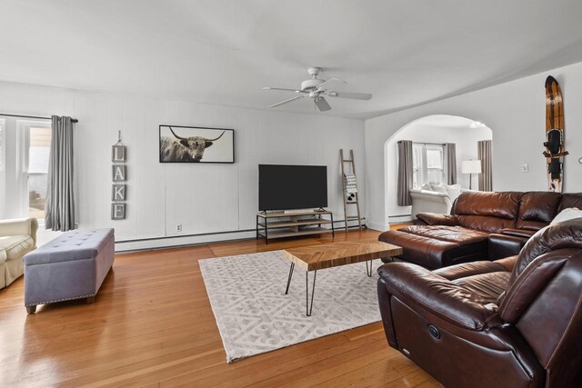 515 Maple Hill Ter, Twin Lakes, WI 53181 - living area featuring wood finished floors, ceiling fan, a baseboard heating unit, and arched walkways