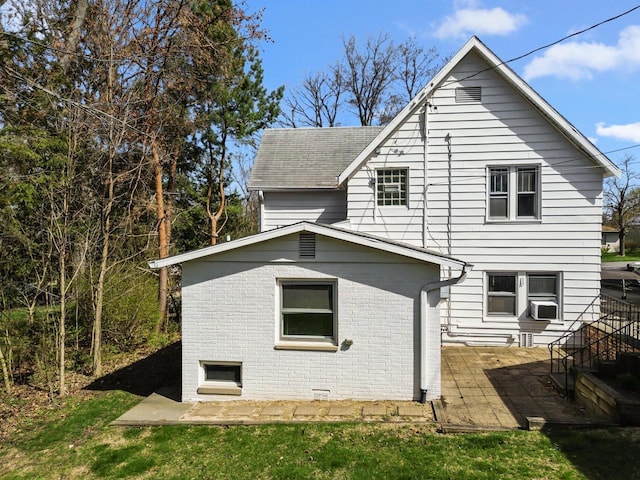 515 Maple Hill Ter, Twin Lakes, WI 53181 - back of house with a lawn, cooling unit, a shingled roof, and brick siding