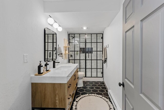 bathroom with vanity, toilet, and baseboards