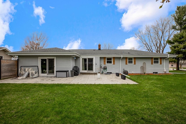 back of property featuring a patio, fence, a chimney, and a lawn