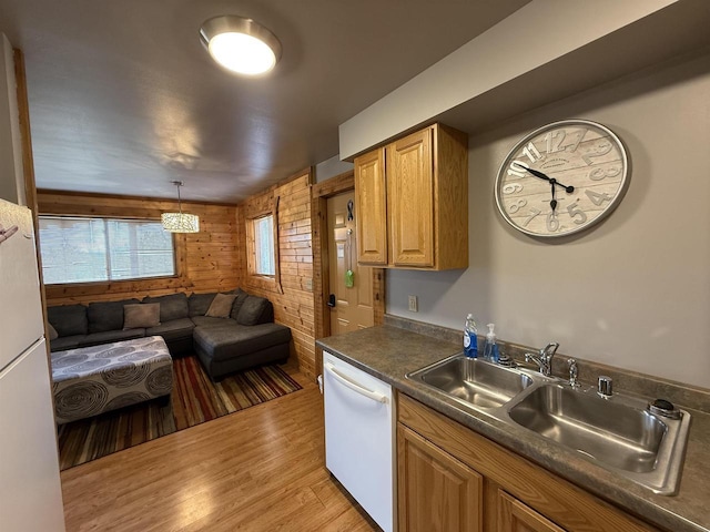475 Overlook Ct, Warrens, WI 54666 - kitchen with a sink, white dishwasher, open floor plan, wooden walls, and light wood-type flooring