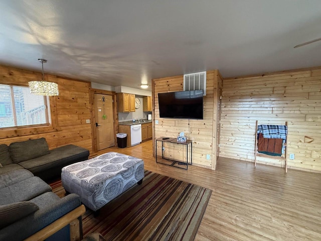 475 Overlook Ct, Warrens, WI 54666 - living area featuring wood walls, visible vents, and light wood finished floors