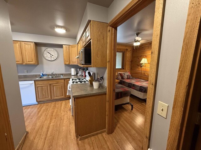 475 Overlook Ct, Warrens, WI 54666 - kitchen featuring dark countertops, white appliances, light wood finished floors, and a sink
