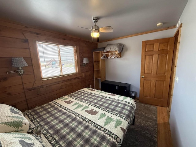 475 Overlook Ct, Warrens, WI 54666 - bedroom with wood walls, wood finished floors, and ceiling fan