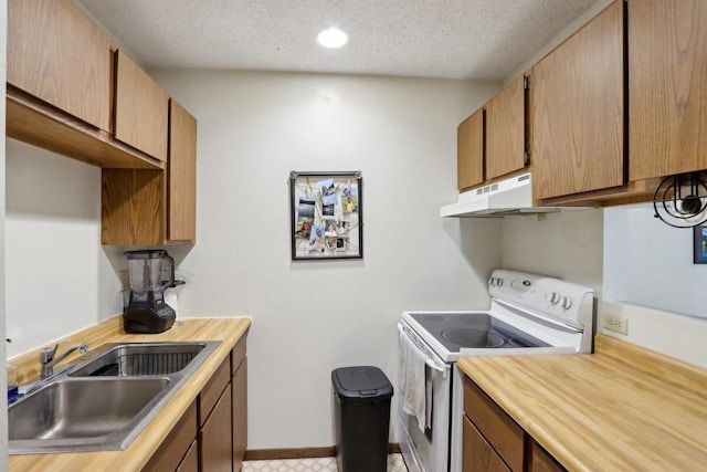 kitchen with under cabinet range hood, light countertops, a sink, white electric range oven, and a textured ceiling