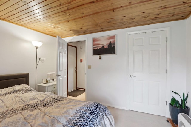 carpeted bedroom with wood ceiling