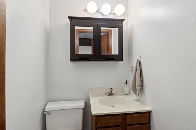 half bath featuring toilet and vanity