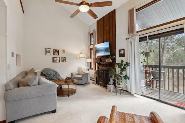 living room with high vaulted ceiling, light carpet, and ceiling fan