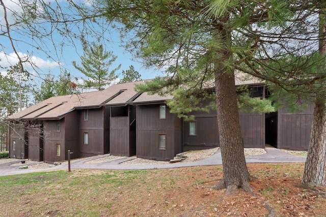 back of property featuring fence and roof with shingles