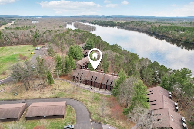 birds eye view of property featuring a wooded view and a water view