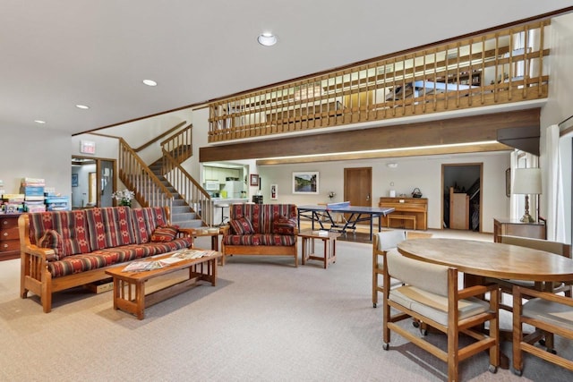 carpeted living area featuring recessed lighting and stairway