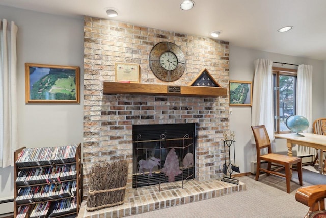 living area featuring a brick fireplace, recessed lighting, and carpet flooring
