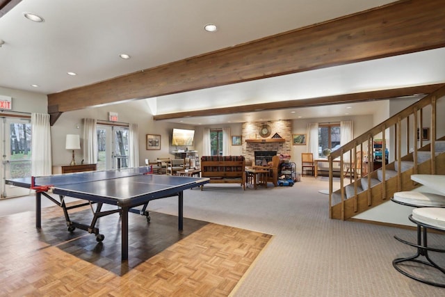rec room with plenty of natural light, recessed lighting, french doors, and a fireplace