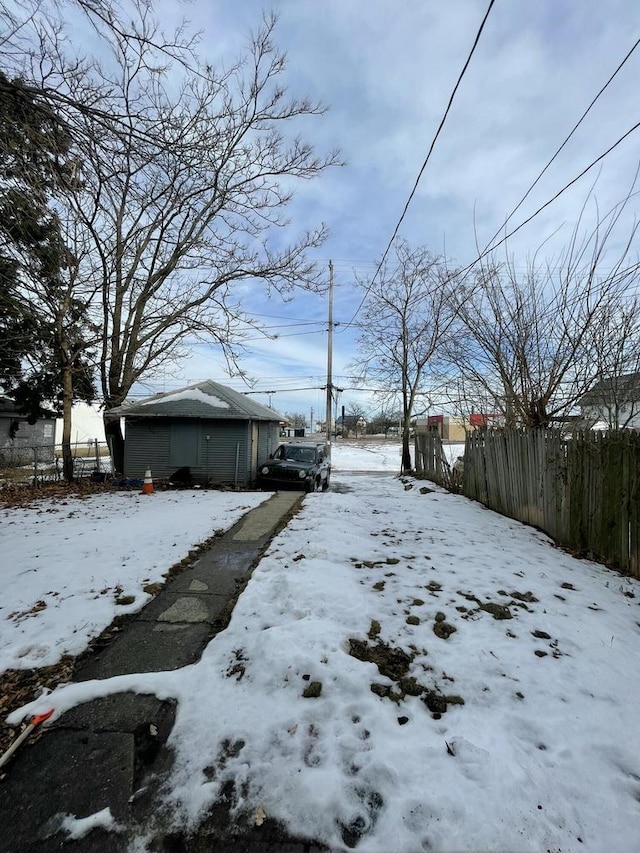 yard covered in snow with fence