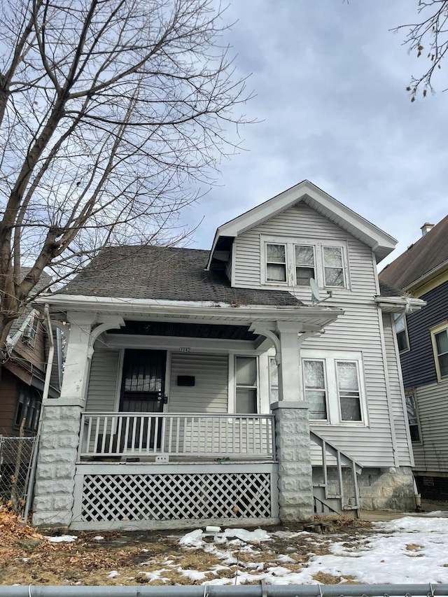 view of front of property with a porch and roof with shingles