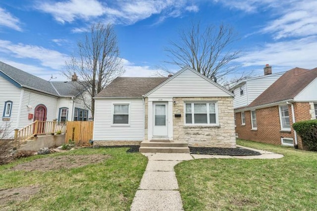 bungalow with a front yard and stone siding