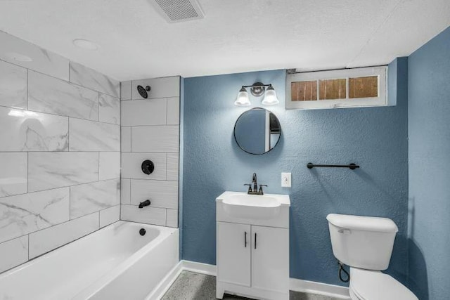 bathroom featuring baseboards, visible vents, toilet, and a textured wall