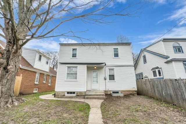 rear view of house featuring fence
