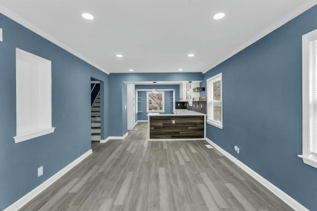 bar with ornamental molding, wood finished floors, and baseboards