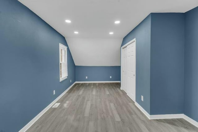 bonus room featuring baseboards, recessed lighting, and wood finished floors