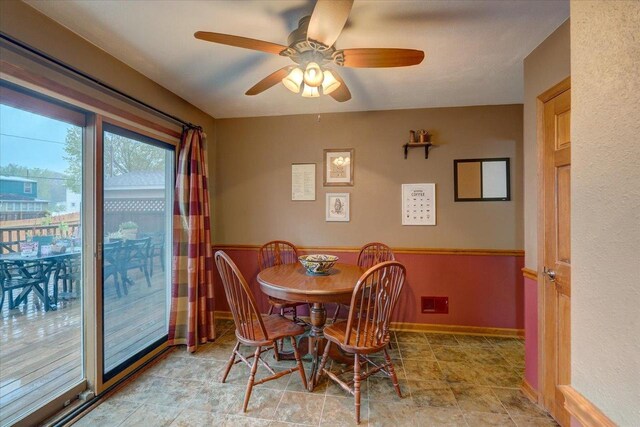 dining area featuring baseboards and ceiling fan
