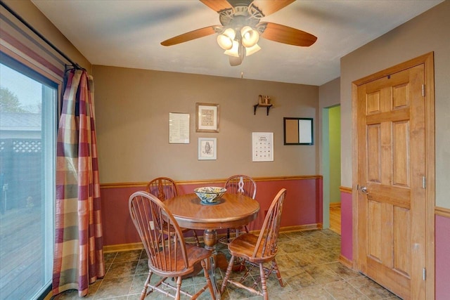 dining room featuring a ceiling fan, baseboards, and light tile patterned floors