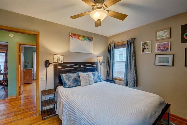 bedroom featuring baseboards, a ceiling fan, and wood finished floors