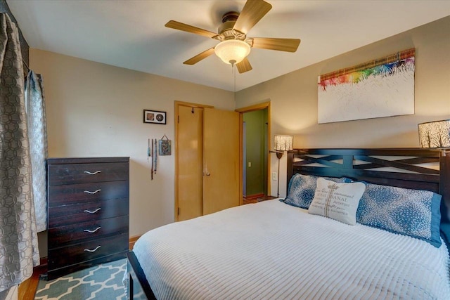 bedroom with a ceiling fan and wood finished floors