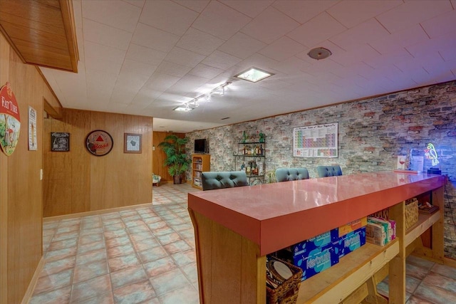 interior space featuring tile patterned floors and wooden walls