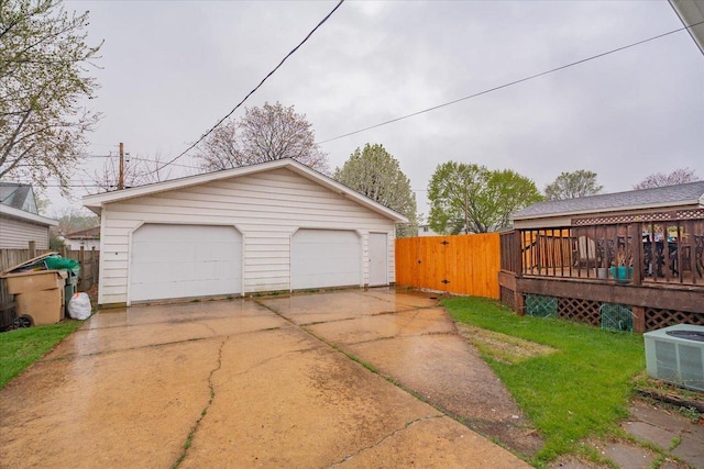 detached garage with fence and central AC unit