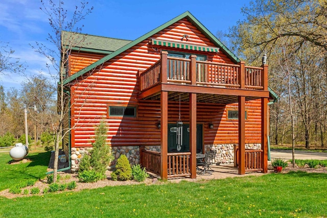W4895 Big Bay Rd, Necedah, WI 54646 - back of house with a lawn, a deck, faux log siding, and a shingled roof