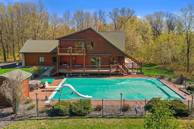 W4895 Big Bay Rd, Necedah, WI 54646 - view of swimming pool featuring a wooden deck, a fenced backyard, a water slide, a patio, and stairway