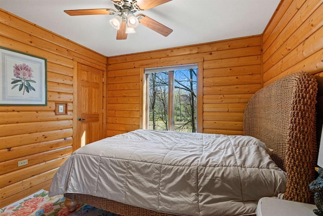 W4895 Big Bay Rd, Necedah, WI 54646 - bedroom featuring log walls, a ceiling fan, and access to outside