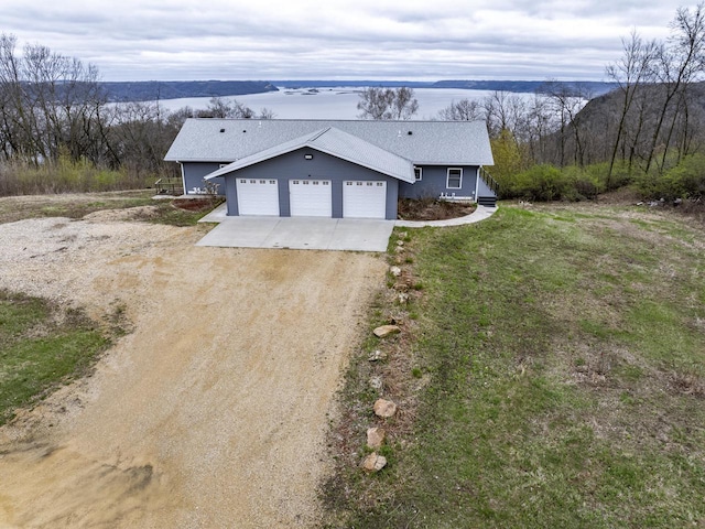 59144 Lucky Ln, Eastman, WI 54626 - view of front of home featuring a garage, dirt driveway, and a shingled roof