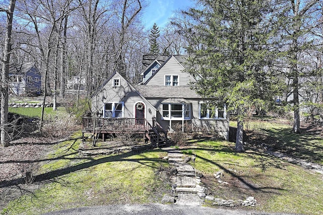 view of front of house with a front lawn and a deck