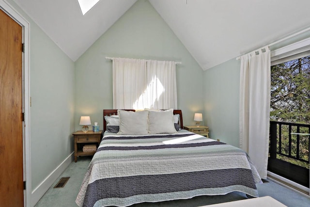 bedroom with vaulted ceiling with skylight, baseboards, carpet flooring, and visible vents