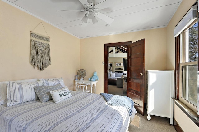 carpeted bedroom featuring crown molding and ceiling fan
