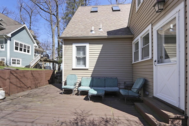 back of house with an outdoor living space, a wooden deck, and a shingled roof