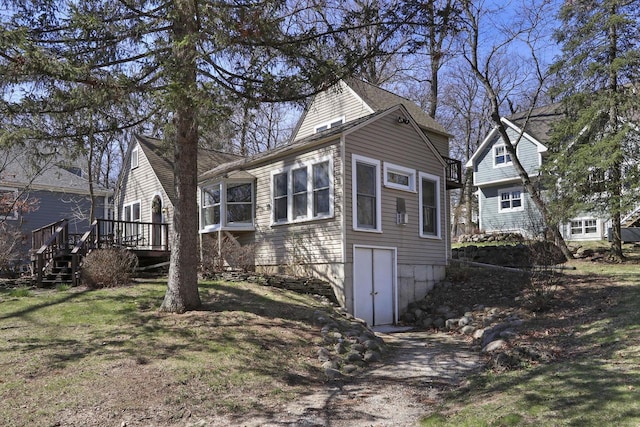 view of side of property with a wooden deck and stairway