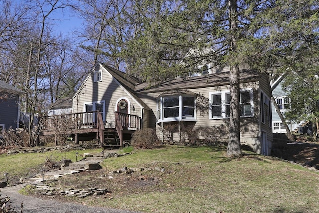 view of front of home featuring a deck and a front lawn