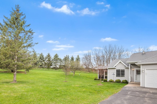 view of yard featuring aphalt driveway