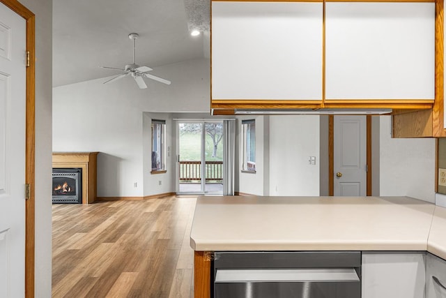 kitchen featuring a peninsula, light countertops, high vaulted ceiling, a ceiling fan, and open floor plan