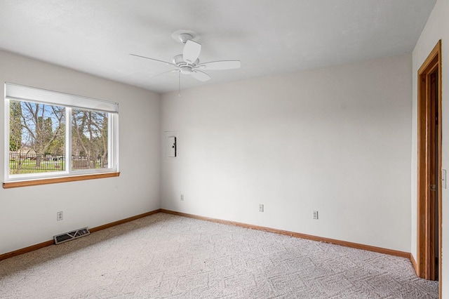 unfurnished room featuring visible vents, ceiling fan, light carpet, and baseboards