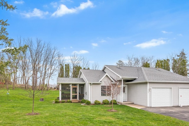 ranch-style home with aphalt driveway, a shingled roof, an attached garage, a front lawn, and a sunroom