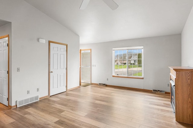 unfurnished bedroom with visible vents, light wood-type flooring, and lofted ceiling